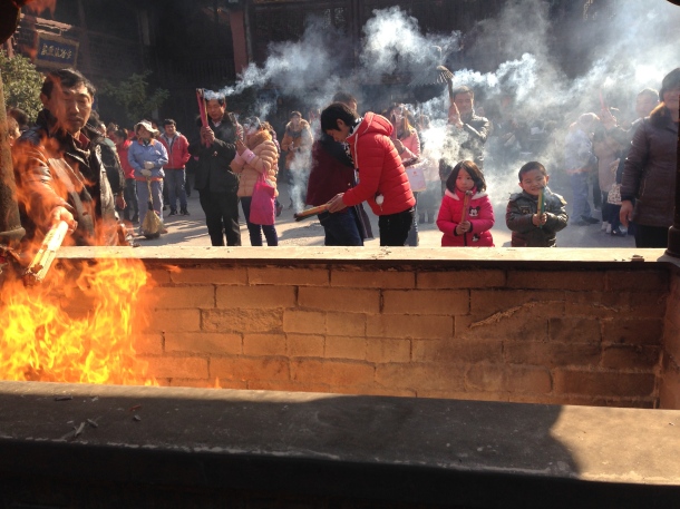 People offering incense to the city gods.